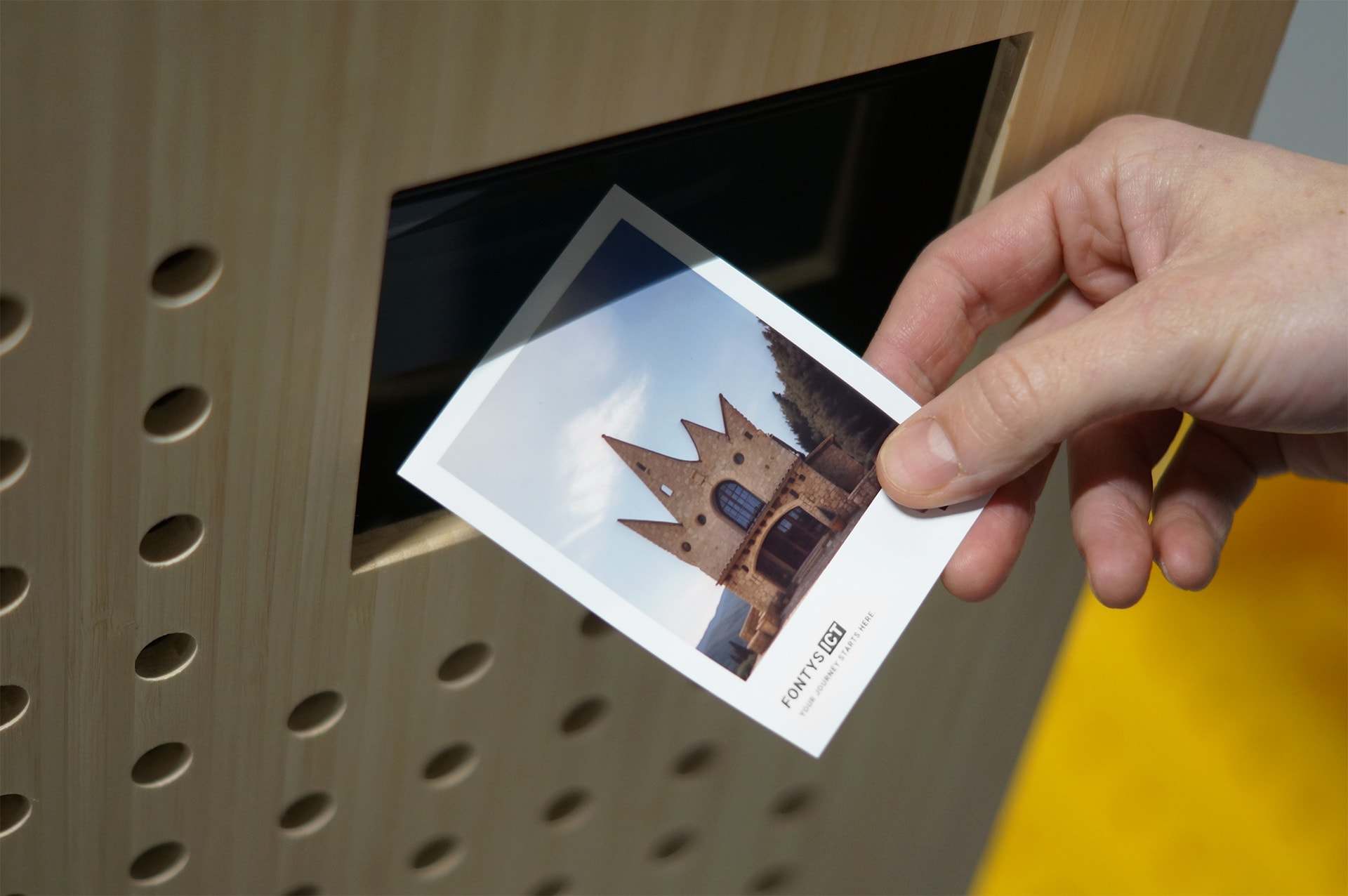 Hand holding an AI rendered print.