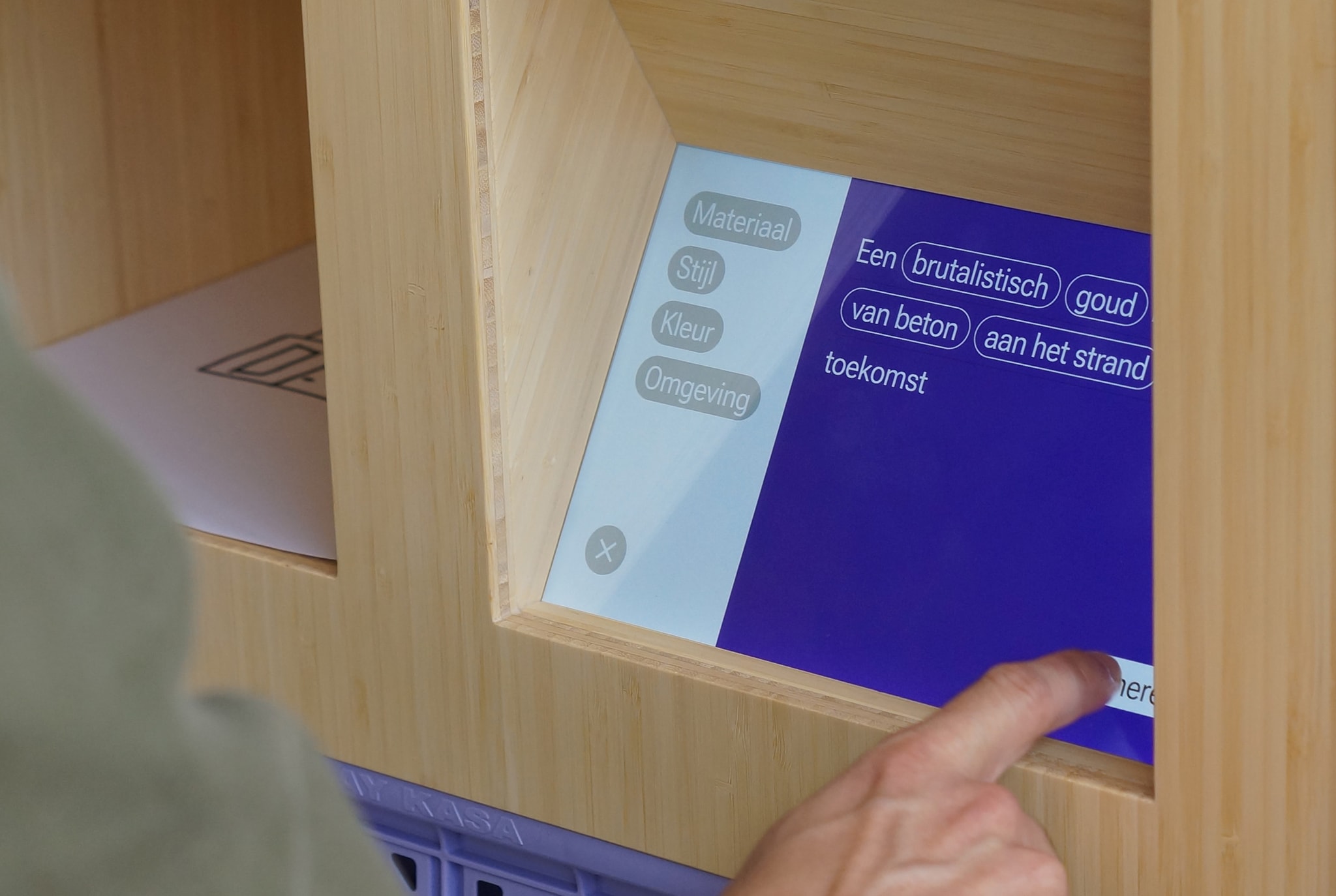 Hand touching a display showing an interface for prompting