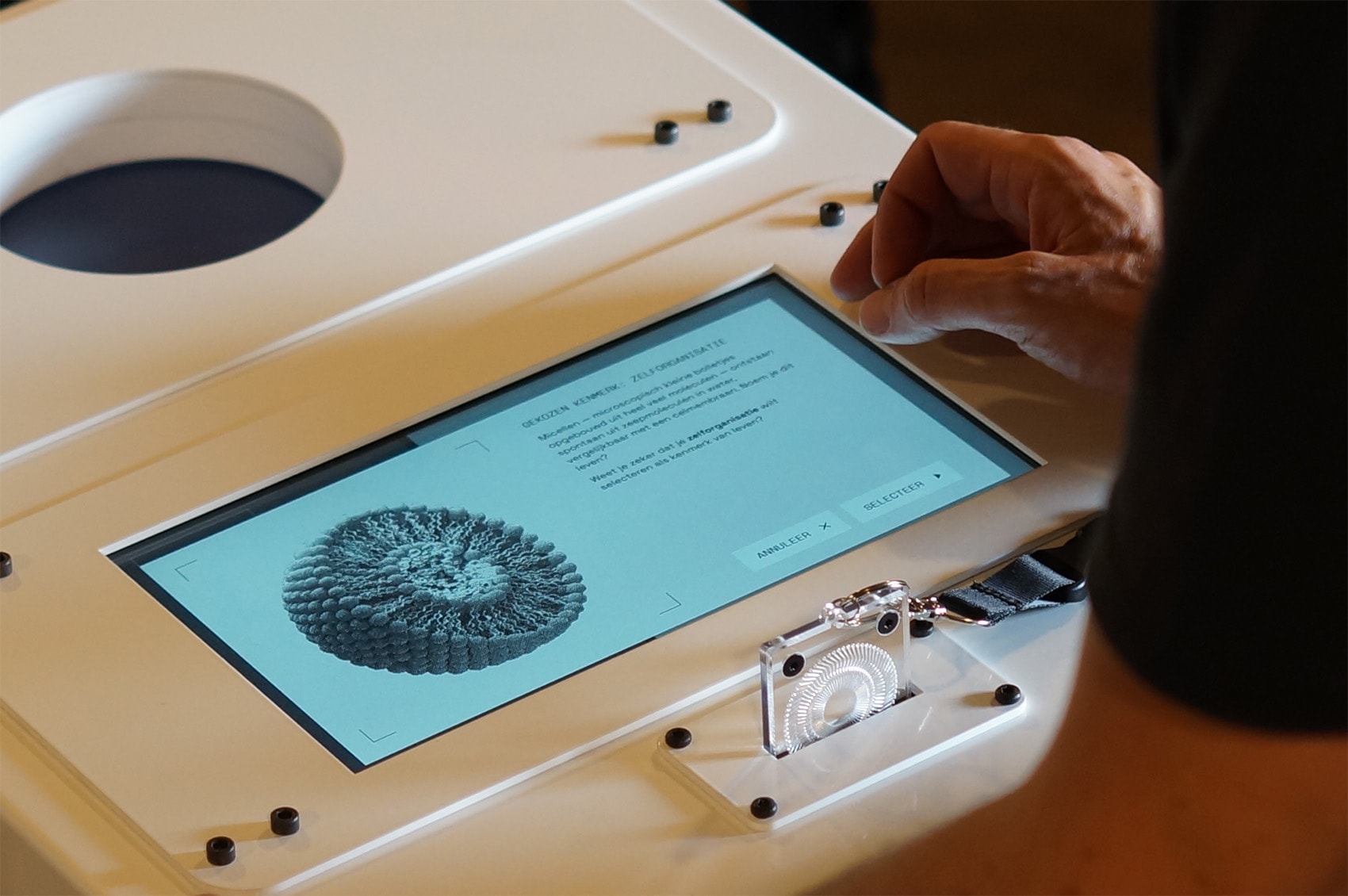 Hand interacting with a custom device that shows different properties of life.